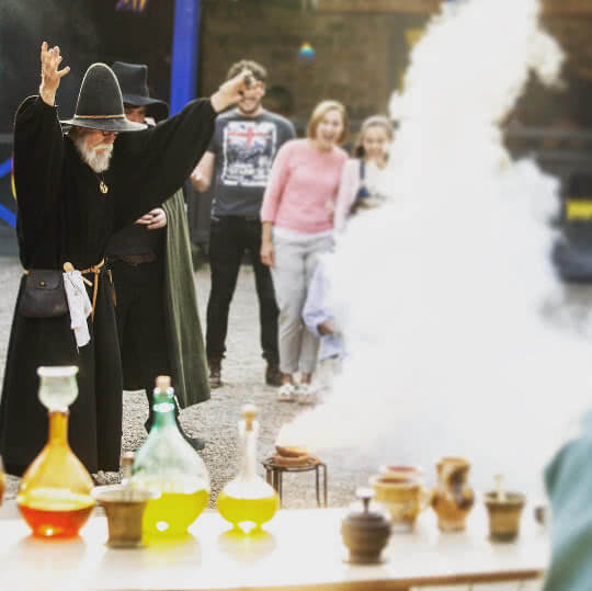 Alnwick Castle's Alchemist brews some potions in Artisans Courtyard