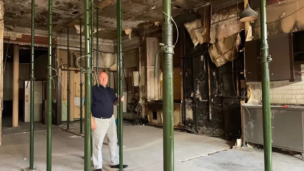 Owner David Taylor stands in the fire-gutted ruin of his Elephant House cafe