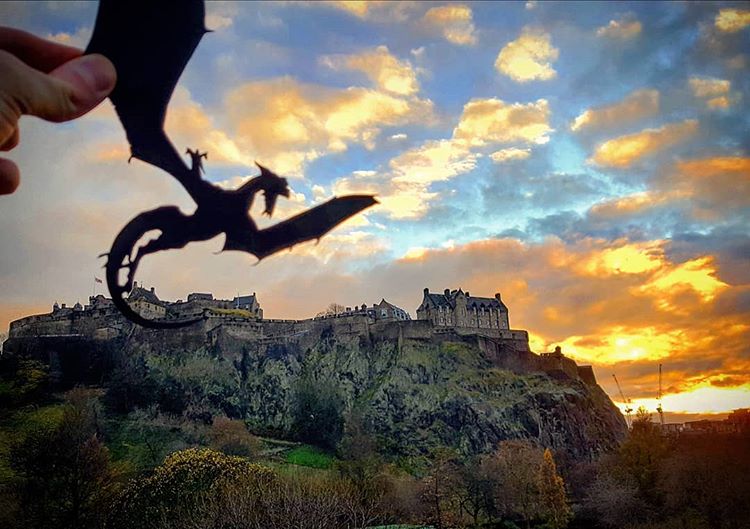 A dragon flies by Edinburgh Castle