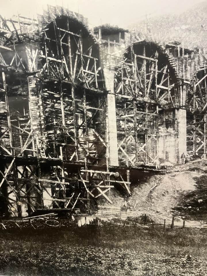 Robert McAlpine's builders construct Glenfinnan Viaduct, towering above the river Finnan