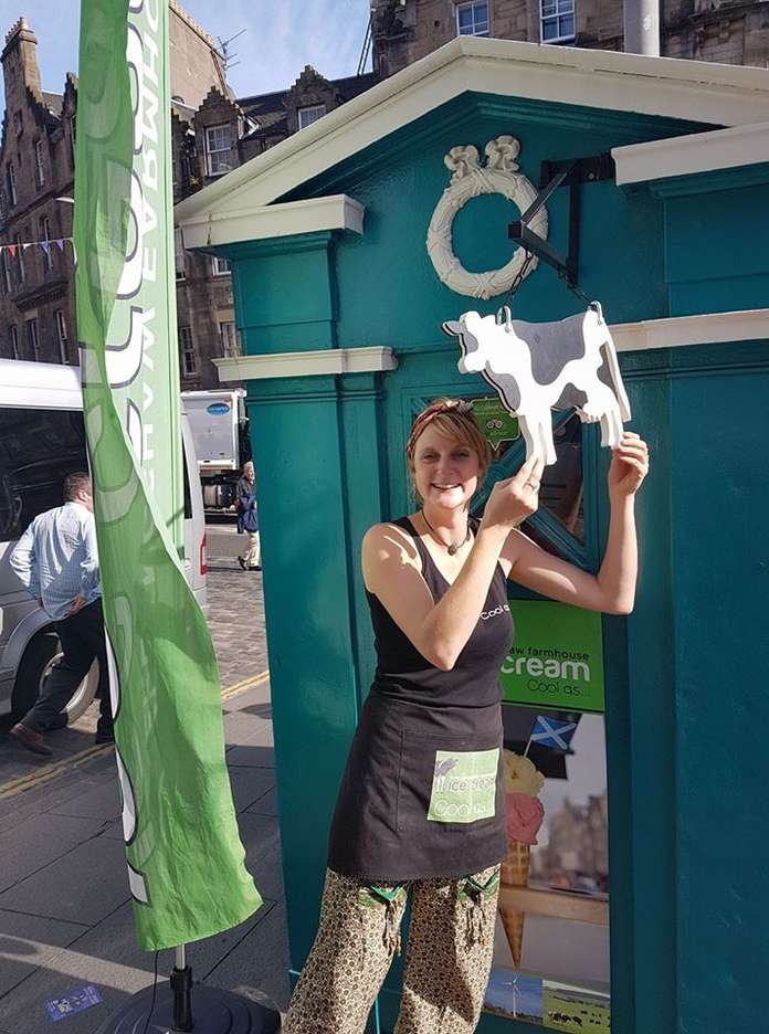 Lucy Bergshaw owner of Overlangshaw Farmhouse ice cream outside her Police box on Edinburgh's Grassmarket