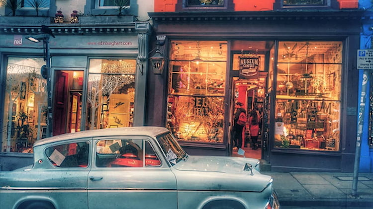 Museum Context’s Harry Potter shop on curvy Victoria Street with Ron Weasley’s blue Ford Anglia parked outside