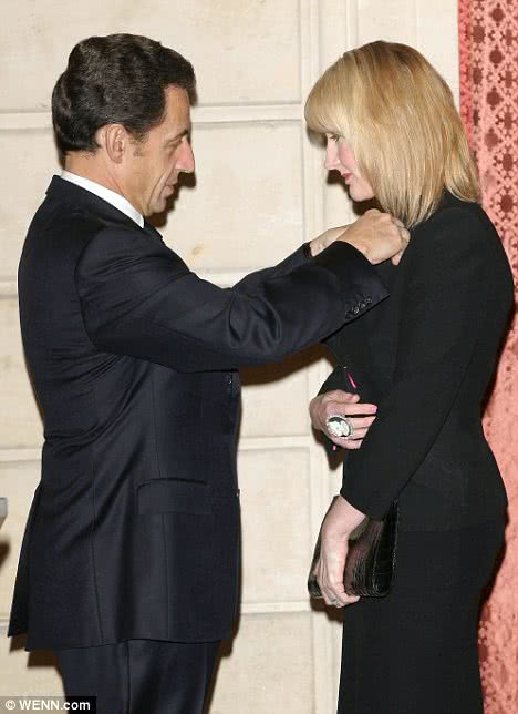 French president Nicholas Sarkozy pins the Legion D'Honour on JK Rowling
