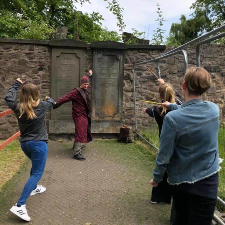 An American family wand duels in front of Tom Riddle's grave in Greyfriars Kirkyard on a private Harry Potter tour of Edinburgh